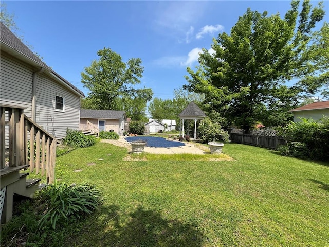 view of yard with a gazebo and an outbuilding