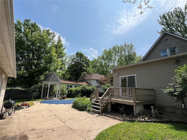 view of yard with a gazebo, a deck, and a patio