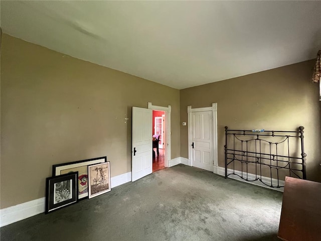 unfurnished bedroom with carpet flooring and baseboards
