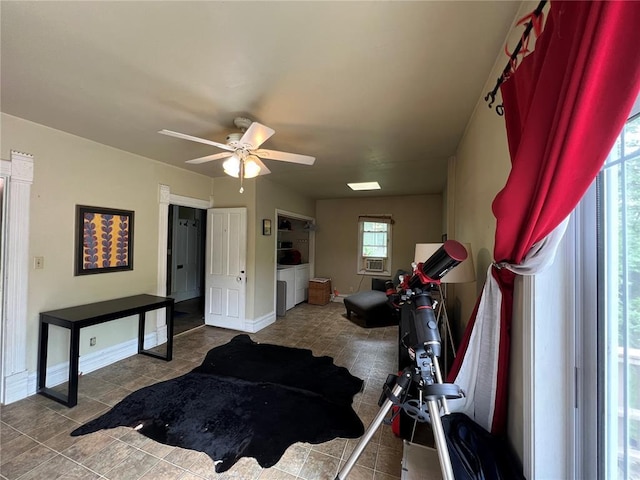 tiled bedroom with baseboards and ceiling fan