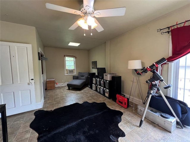 workout room featuring tile patterned floors, ceiling fan, and baseboards