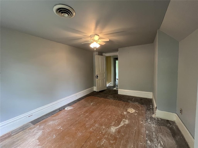 spare room featuring baseboards, hardwood / wood-style floors, and ceiling fan