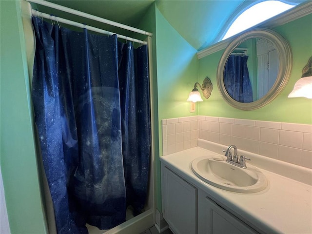 bathroom featuring vanity, a shower with shower curtain, and lofted ceiling