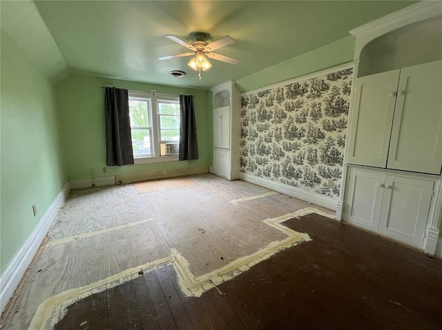 spare room featuring hardwood / wood-style floors, a ceiling fan, baseboards, cooling unit, and lofted ceiling