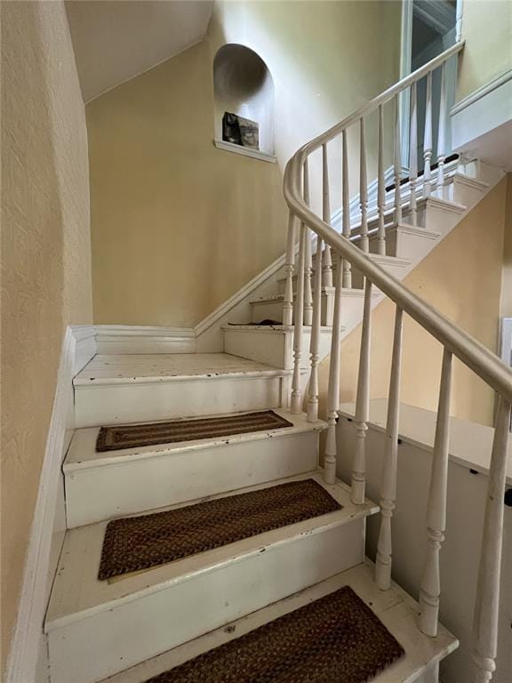 staircase with vaulted ceiling