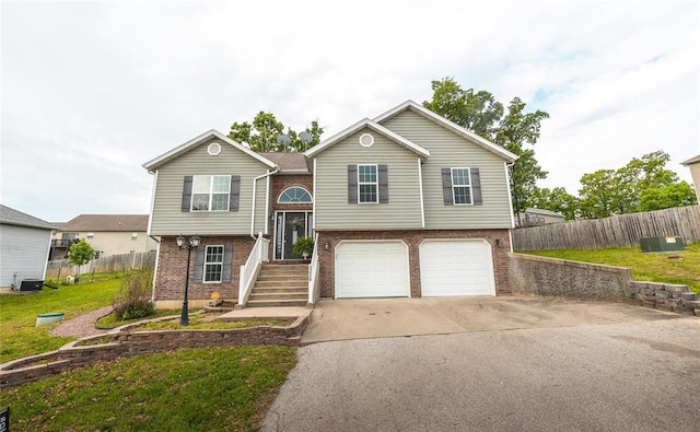 23529 Restore Rd, Waynesville, MO 65583 - raised ranch featuring brick siding, concrete driveway, a garage, and central AC