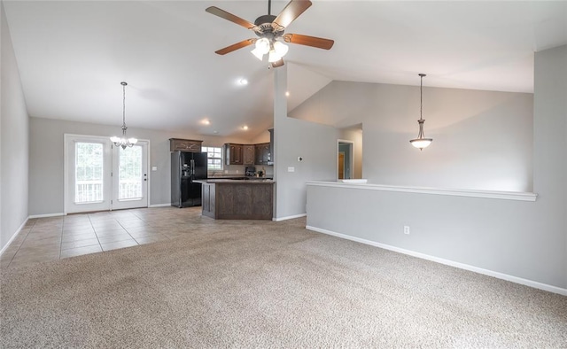 23529 Restore Rd, Waynesville, MO 65583 - kitchen featuring black fridge, open floor plan, vaulted ceiling, dark brown cabinetry, and baseboards