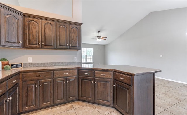 23529 Restore Rd, Waynesville, MO 65583 - kitchen with vaulted ceiling, light tile patterned floors, ceiling fan, a peninsula, and dark brown cabinetry