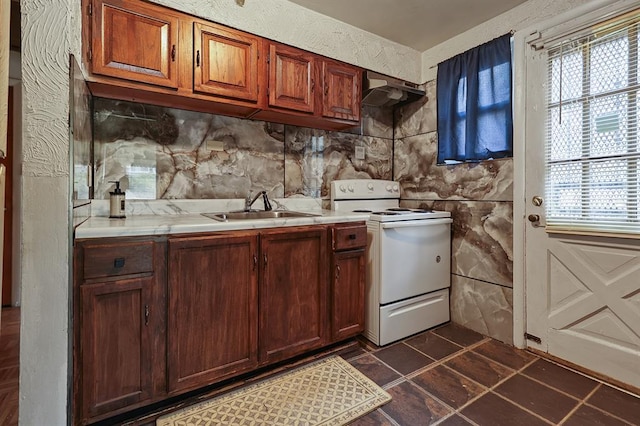 8909 Tutwiler Ave, Berkeley, MO 63134 - kitchen featuring white range with electric stovetop, a sink, light countertops, under cabinet range hood, and tasteful backsplash