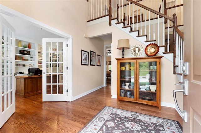 230 Merlot Ln, Saint Albans, MO 63073 - foyer entrance featuring french doors, wood finished floors, baseboards, stairs, and a high ceiling