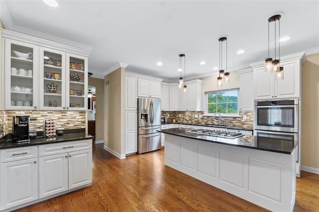 230 Merlot Ln, Saint Albans, MO 63073 - kitchen with stainless steel appliances, a sink, white cabinets, decorative backsplash, and wood finished floors