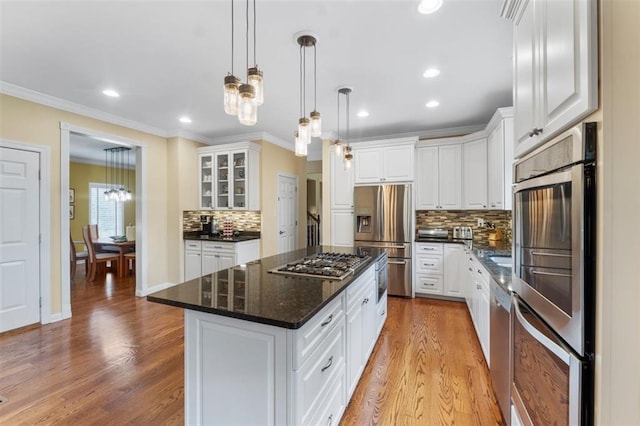 230 Merlot Ln, Saint Albans, MO 63073 - kitchen featuring stainless steel appliances, a kitchen island, backsplash, white cabinets, and light wood-style floors