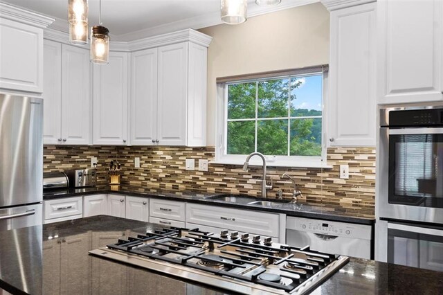 230 Merlot Ln, Saint Albans, MO 63073 - kitchen featuring appliances with stainless steel finishes, a sink, white cabinetry, decorative backsplash, and crown molding