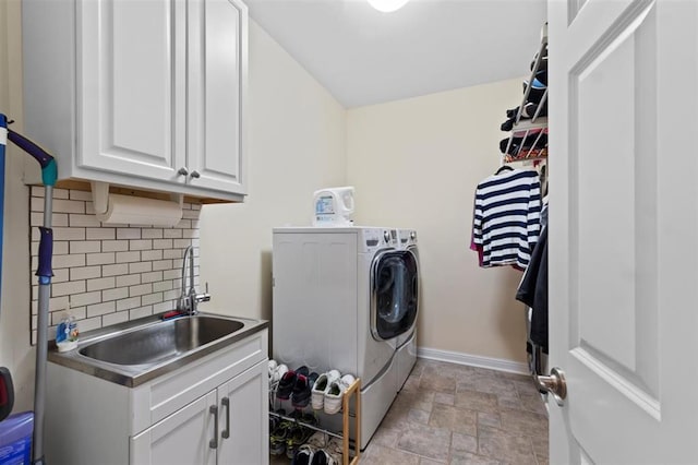 230 Merlot Ln, Saint Albans, MO 63073 - washroom with washer and clothes dryer, cabinet space, stone finish flooring, and baseboards
