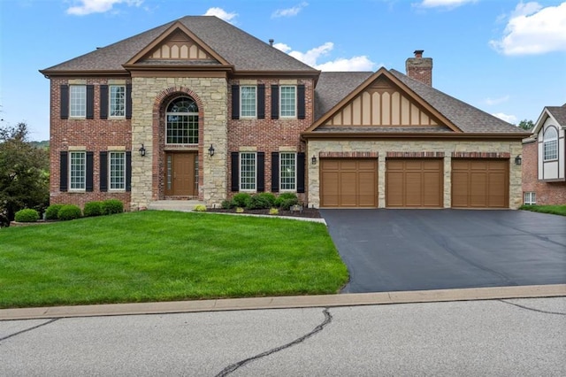 230 Merlot Ln, Saint Albans, MO 63073 - view of front facade featuring stone siding, asphalt driveway, a front lawn, and an attached garage