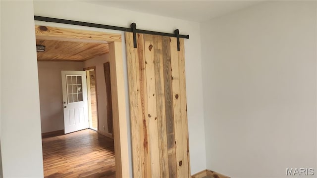 229 S Main St, Licking, MO 65542 - hall featuring wood finished floors, wooden ceiling, and a barn door