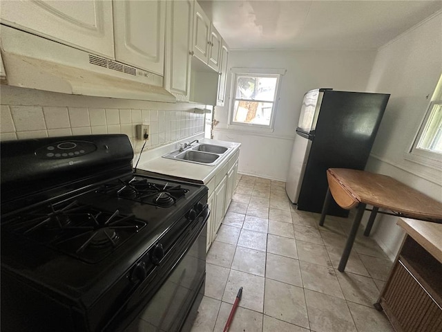 6501 Stratford Ave, Pine Lawn, MO 63120 - kitchen featuring gas stove, a sink, freestanding refrigerator, and healthy amount of natural light