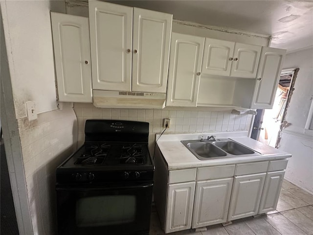 6501 Stratford Ave, Pine Lawn, MO 63120 - kitchen with black gas range, a sink, under cabinet range hood, and white cabinets
