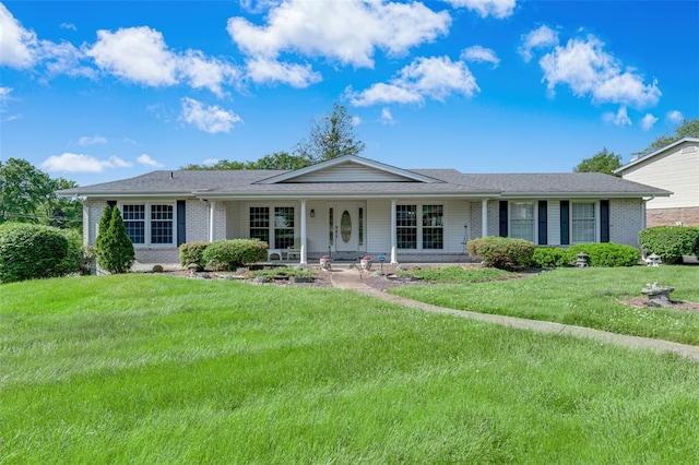 single story home with brick siding, a porch, and a front yard