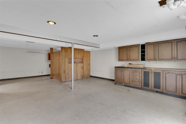 finished basement with baseboards and recessed lighting