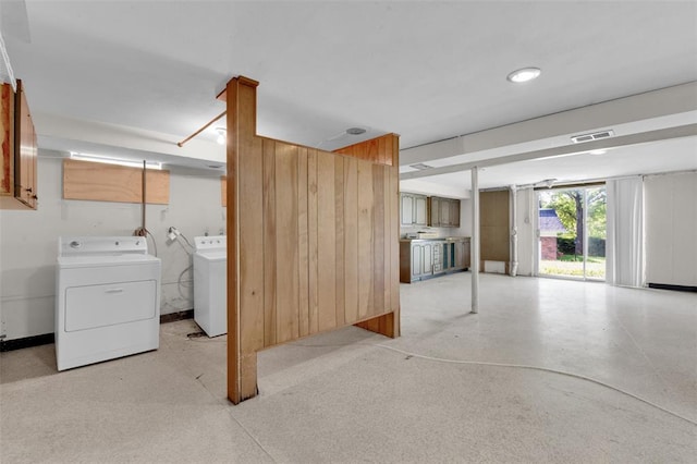 unfurnished living room featuring washer and clothes dryer