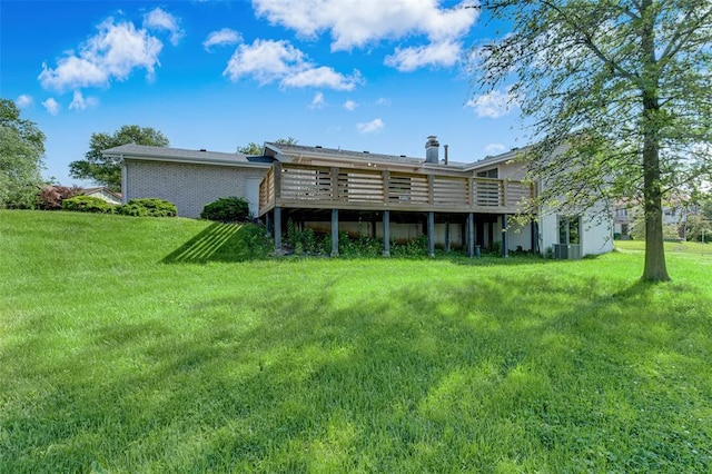 back of property featuring a deck and a yard