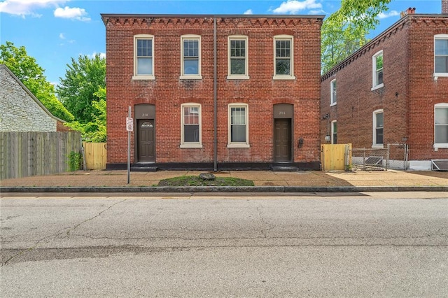 214 W Steins, Saint Louis, MO 63111 - view of front facade featuring brick siding and fence