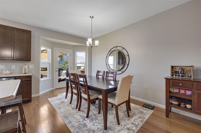 1051 Timber Creek Ln, Imperial, MO 63052 - dining room with baseboards, light wood-style flooring, and a chandelier