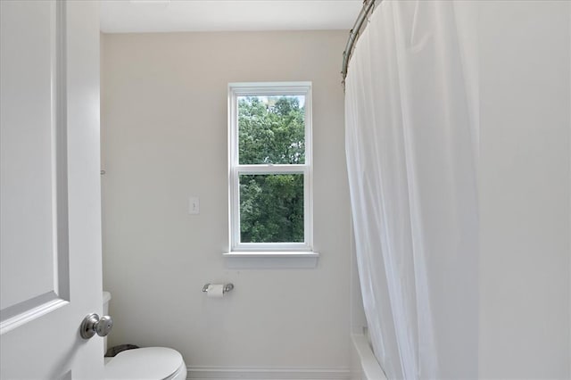 1051 Timber Creek Ln, Imperial, MO 63052 - bathroom with toilet, shower / bath combination with curtain, and baseboards