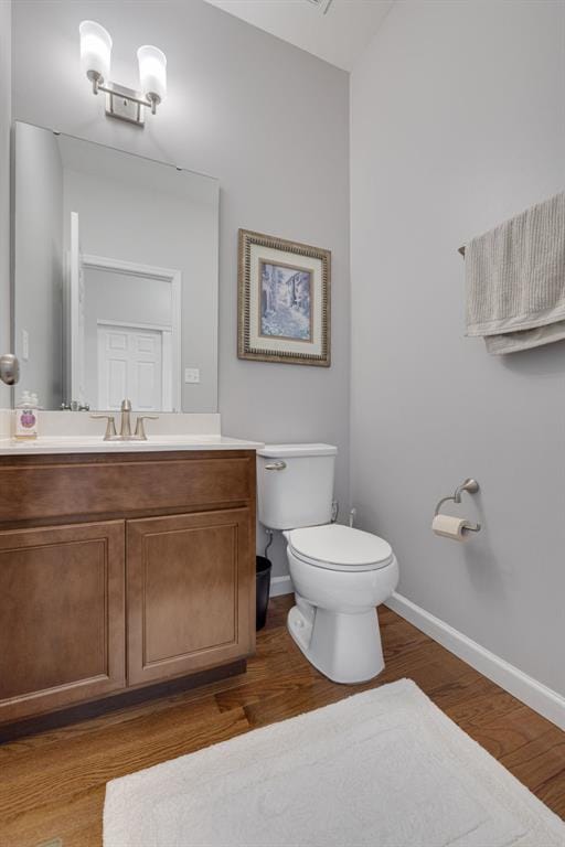 1051 Timber Creek Ln, Imperial, MO 63052 - half bath with vanity, toilet, wood finished floors, and baseboards