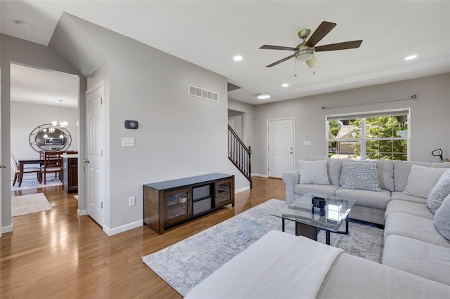 1051 Timber Creek Ln, Imperial, MO 63052 - living room featuring stairs, wood finished floors, a ceiling fan, a chandelier, and baseboards