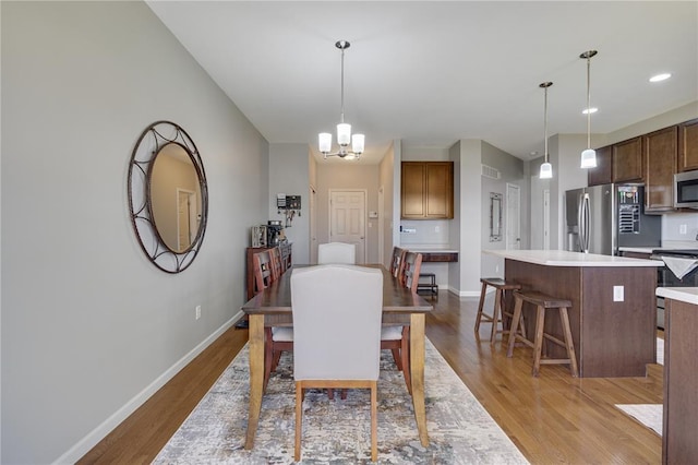 1051 Timber Creek Ln, Imperial, MO 63052 - dining area featuring wood finished floors, baseboards, and a chandelier