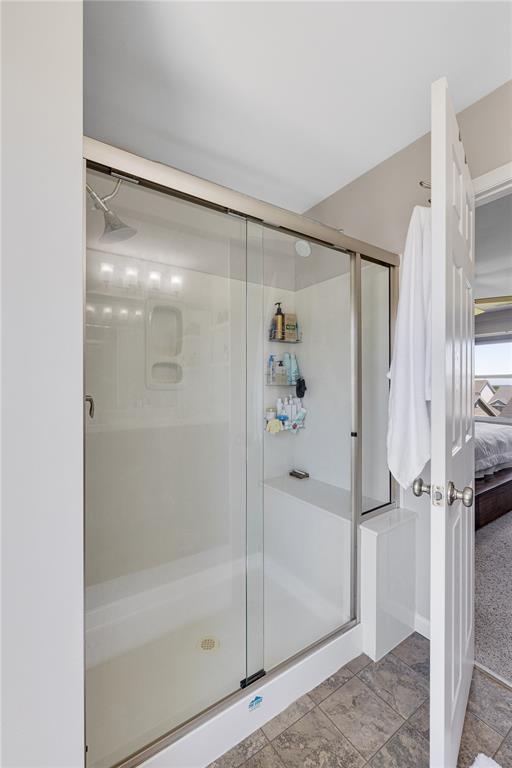 1051 Timber Creek Ln, Imperial, MO 63052 - ensuite bathroom with a stall shower and stone finish flooring