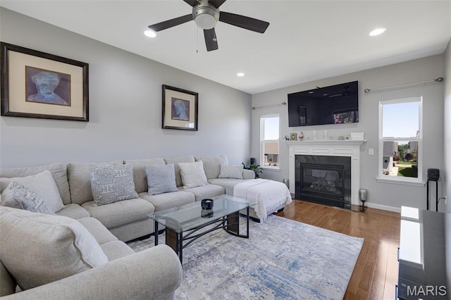1051 Timber Creek Ln, Imperial, MO 63052 - living room with ceiling fan, wood finished floors, recessed lighting, and a glass covered fireplace