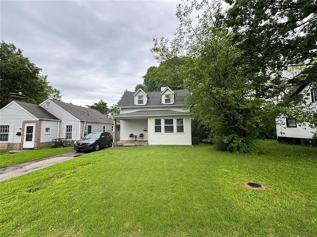 view of front of home with a front yard, a porch, asphalt driveway, and a shingled roof