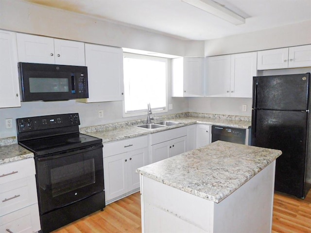 kitchen with black appliances, a sink, light wood-type flooring, and white cabinets