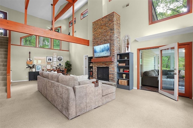 19072 Bear Trail Rd, Glencoe, MO 63038 - living room featuring a towering ceiling, carpet, plenty of natural light, and a stone fireplace