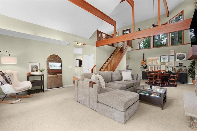 19072 Bear Trail Rd, Glencoe, MO 63038 - carpeted living area with high vaulted ceiling, baseboards, stairs, beamed ceiling, and ceiling fan