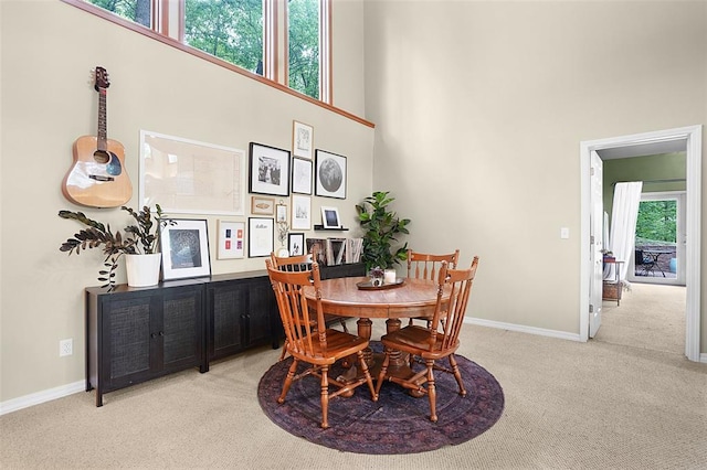 19072 Bear Trail Rd, Glencoe, MO 63038 - dining area featuring light carpet, a high ceiling, and baseboards