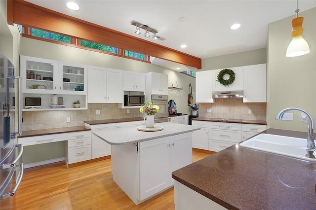 19072 Bear Trail Rd, Glencoe, MO 63038 - kitchen featuring a sink, stainless steel appliances, a center island, tasteful backsplash, and white cabinetry