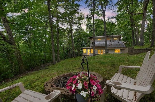 19072 Bear Trail Rd, Glencoe, MO 63038 - yard at dusk featuring an outdoor fire pit and a lawn