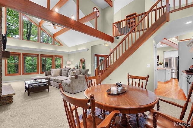 19072 Bear Trail Rd, Glencoe, MO 63038 - dining space with high vaulted ceiling, a ceiling fan, and stairs
