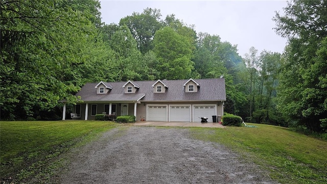 189 County Road 657, Cape Girardeau, MO 63701 - cape cod house featuring driveway, a front lawn, an attached garage, and covered porch
