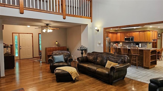 189 County Road 657, Cape Girardeau, MO 63701 - living room featuring a towering ceiling, ceiling fan, and light wood-type flooring