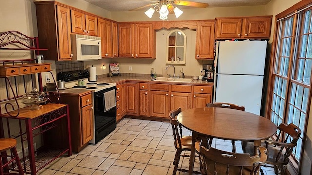 189 County Road 657, Cape Girardeau, MO 63701 - kitchen with white appliances, a sink, a ceiling fan, and brown cabinets