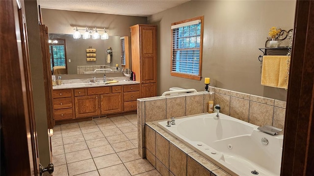 189 County Road 657, Cape Girardeau, MO 63701 - bathroom with a whirlpool tub, vanity, tile patterned flooring, a textured ceiling, and healthy amount of natural light
