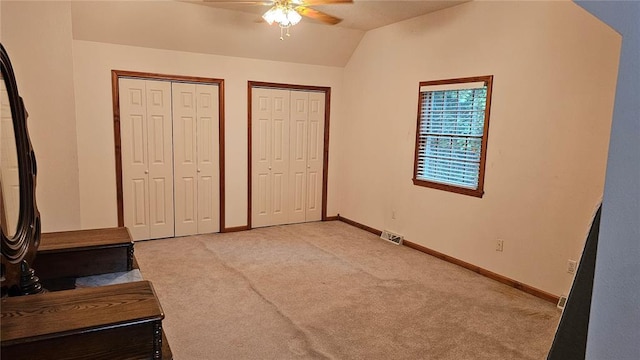189 County Road 657, Cape Girardeau, MO 63701 - unfurnished bedroom featuring two closets, light colored carpet, lofted ceiling, baseboards, and ceiling fan