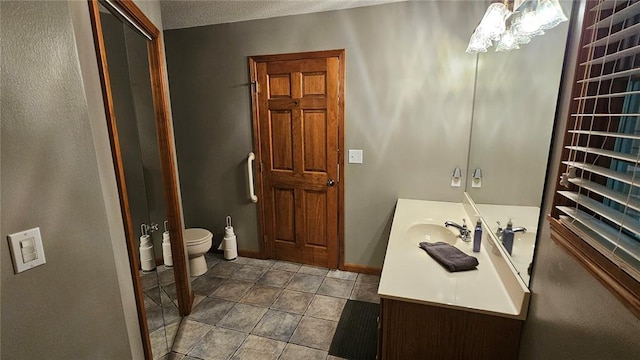 189 County Road 657, Cape Girardeau, MO 63701 - bathroom with vanity, a chandelier, baseboards, tile patterned flooring, and toilet