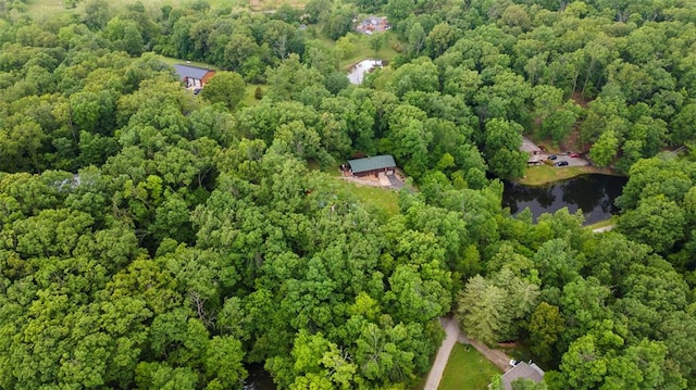aerial view of property and surrounding area featuring a forest