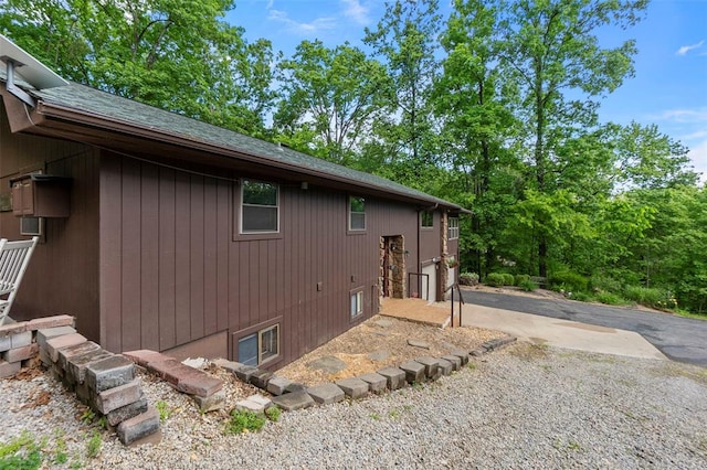 view of property exterior featuring a shingled roof